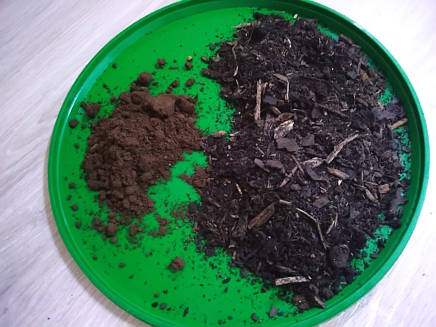 A patic container filled with garden and potting soil.